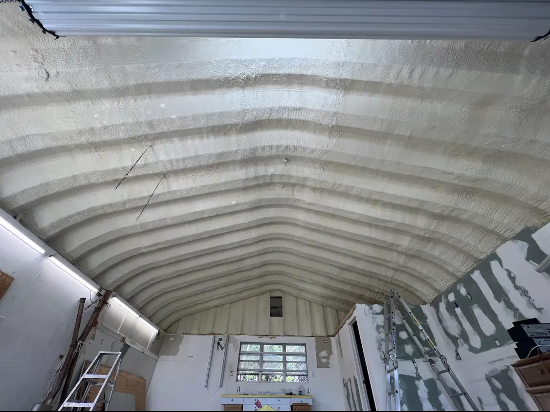 Spray polyurethane foam applied to the underside of a metal roof deck in Redford